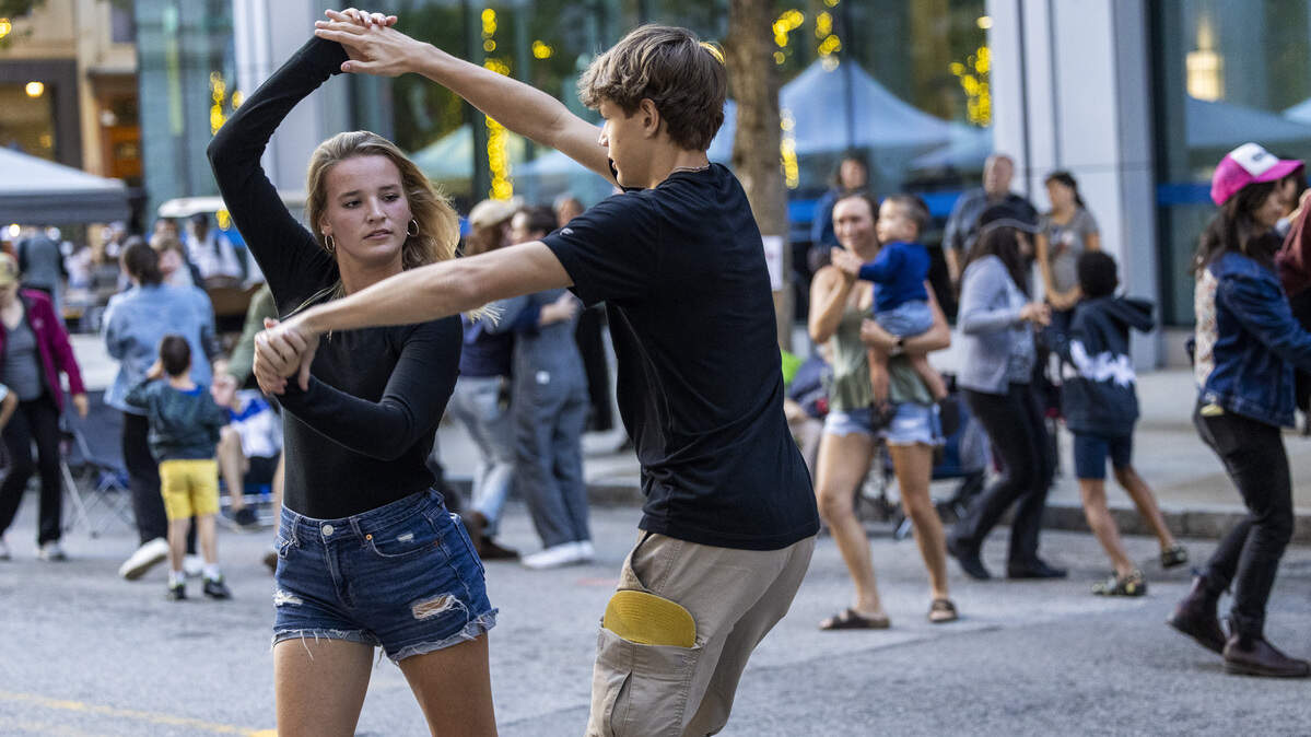 Festival-goers square dance on Martin Street during the Raleigh Wide Open music festival in downtown Raleigh on Friday, Oct. 3, 2025. The event features live bluegrass, folk, Americana and gospel artists.
