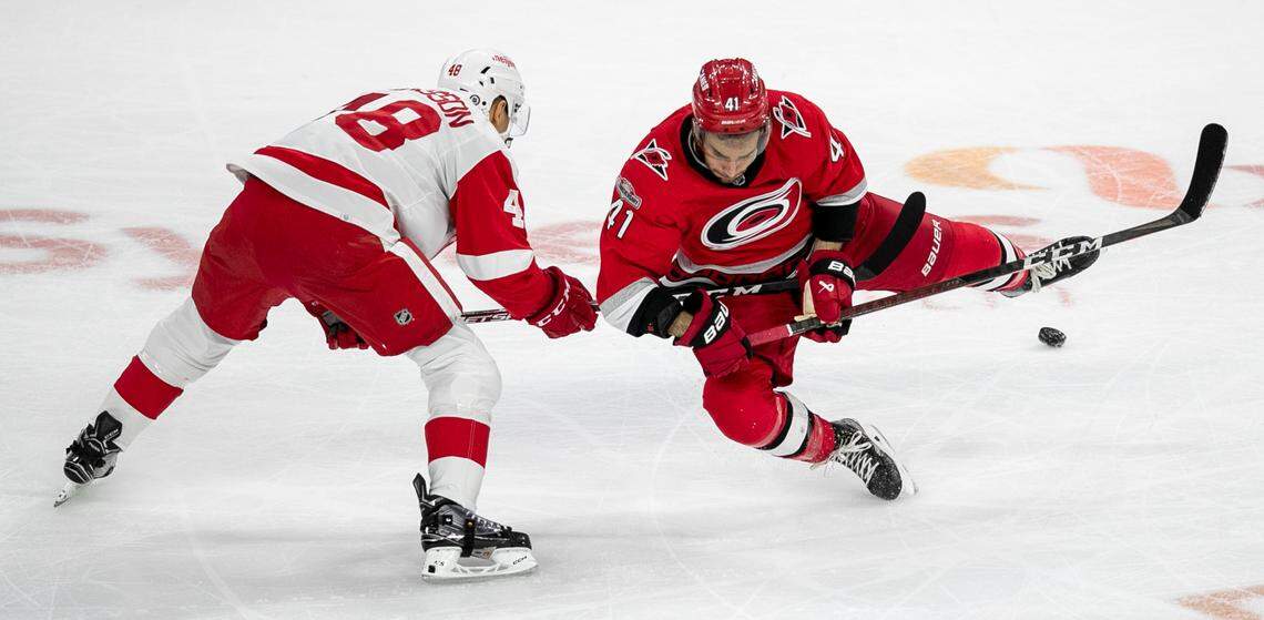 Detroit’s Alex Chiasson (48) collides with Carolina Hurricanes’ Shayne Gostisbehere (41) in the second period on Tuesday, April 11, 2023 at PNC Arena in Raleigh, N.C.
