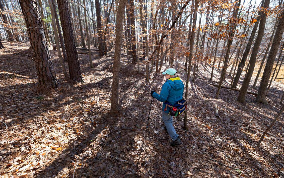 Jean Spooner walks in Umstead State Park near Cary, N.C., near the area that is owned by Raleigh-Durham International Airport Thursday, Jan. 11, 2024. Wake Stone Corporation has a mineral lease on the RDU land and plans to build a stone quarry there.