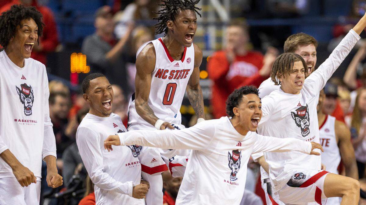 N.C. State’s Terquavion Smith (0) and the Wolfpack bench react after a dunk by Ernest Ross (24) to secure their 97-77 victory over Virginia Tech in the second round of the ACC Tournament on Wednesday, March 8, 2023 at the Greensboro Coliseum in Greensboro, N.C.