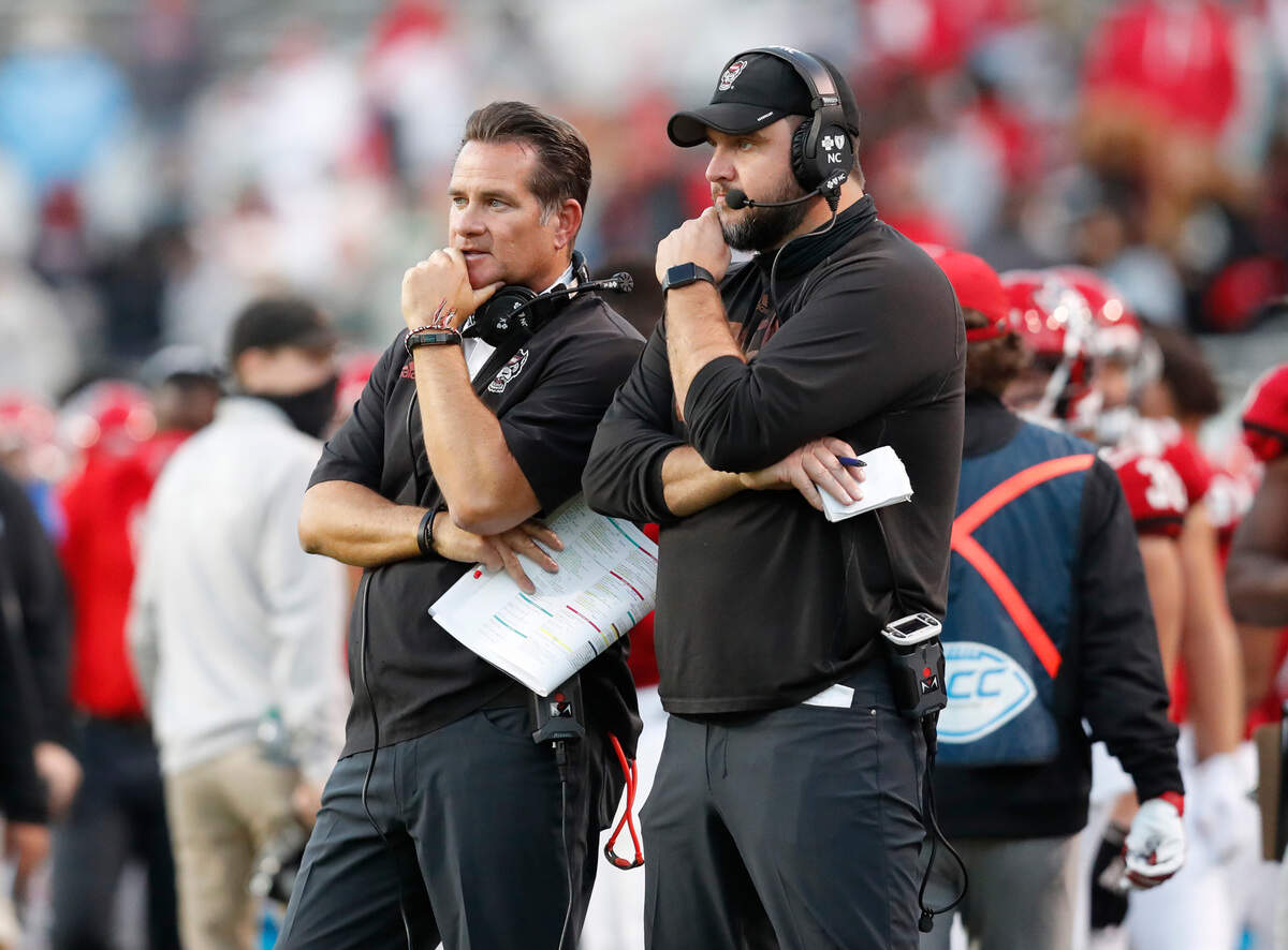 N.C. State offensive coordinator Tim Beck, left, talks with offensive line coach John Garrison during the second half of N.C. State’s 31-20 victory over Duke at Carter-Finley Stadium in Raleigh, N.C., Saturday, Oct. 17, 2020.