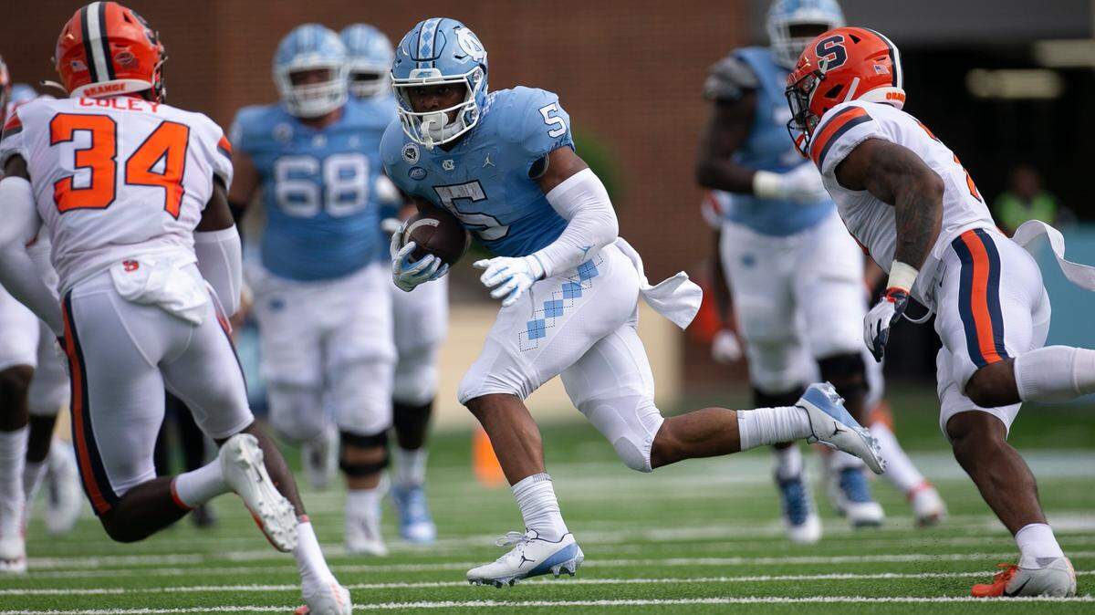 North Carolina’s Dazz Newsome (5) looks for running room against the Syracuse defense in the first quarter at Kenan Stadium on Saturday, September 12, 2020 in Chapel Hill, N.C.