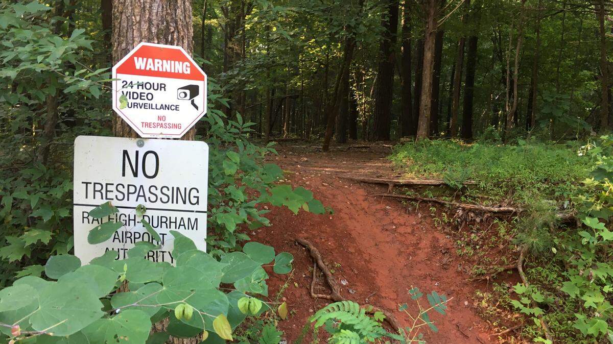 The Raleigh-Durham International Airport Authority has put no trespassing signs on its land on both sides of Old Reedy Creek Road near Umstead State Park. Wake County is proposing to lease 151 acres from RDU and open it to the public.