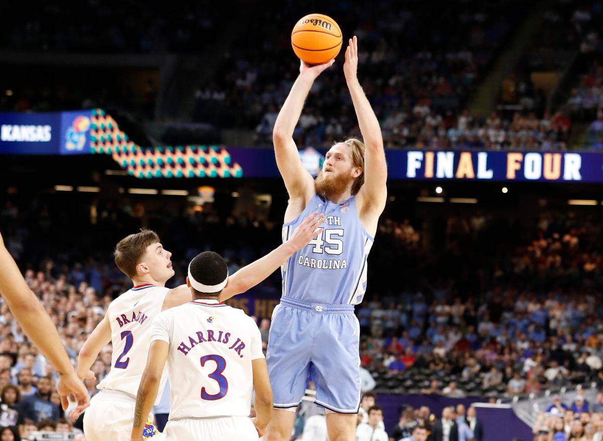 North Carolina’s Brady Manek (45) shoots as Kansas’ Christian Braun (2) defends during the first half of UNC’s game against Kansas in the NCAA Men’s National Championship at the Caesars Superdome in New Orleans, La., Monday, April 4, 2022.