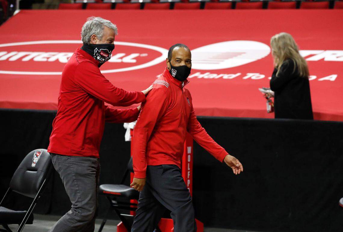 N.C. State Athletics Director Boo Corrigan congratulates head coach Kevin Keatts as they walk off the court after N.C. State’s 79-76 victory over UNC at PNC Arena in Raleigh, N.C., Tuesday, December 22, 2020.