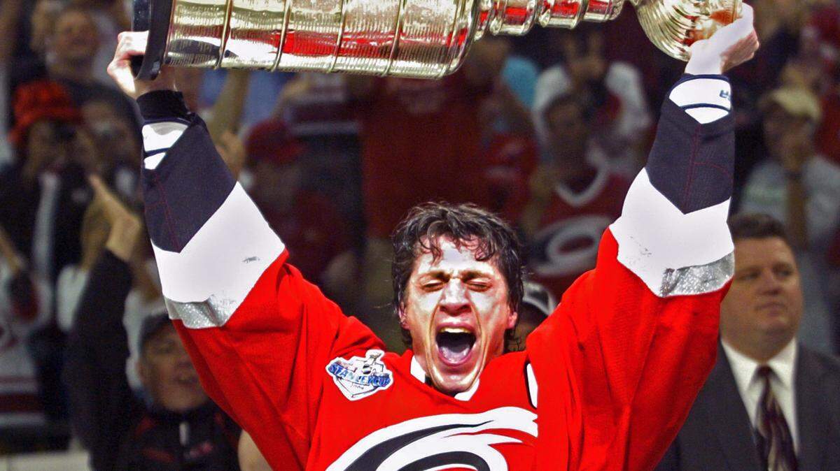 The Canes captain Rod Brind’Amour hoists the Staley Cup in celebration after the Canes defeated the Edmonton Oilers in Game 7 at the RBC Center in Raleigh on June 19, 2006.