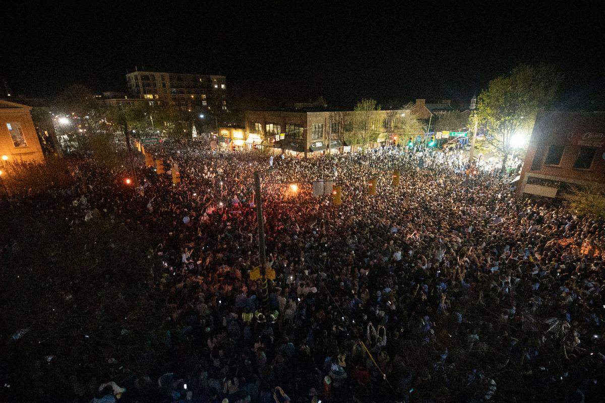 Tar Heel fans filled the intersection of Franklin and Columbia Streets in Chapel Hill, N.C. after their team won against Duke in a historic Final Four game on Saturday, April 2, 2022.