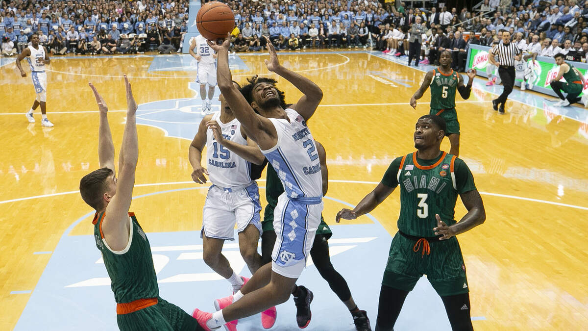 North Carolina’s Coby White (2) drives to the basket against Miami’s Anthony Lawrence II (3) for two of his game high 33 points on Saturday, February 9, 2019 at the Smith Center in Chapel Hill, N.C.