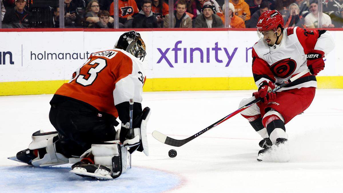 PHILADELPHIA, PENNSYLVANIA - DECEMBER 13: Seth Jarvis #24 of the Carolina Hurricanes scores a goal against Samuel Ersson #33 of the Philadelphia Flyers during the third period at Xfinity Mobile Arena on December 13, 2025 in Philadelphia, Pennsylvania. (Photo by Emilee Chinn/Getty Images)