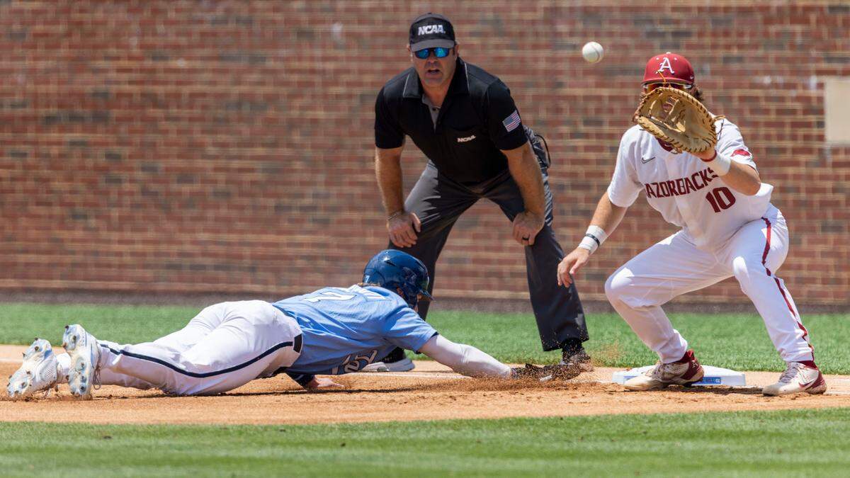 North Carolinaís Vance Honeycutt (7) beats the throw by Arkansas pitcher Will McEntire (41) to first baseman Peyton Stovall (10) in the first inning during game two of their NCAA Super Regional series on Sunday, June 12, 2022 at Boshamer Stadium in Chapel Hill, N.C.