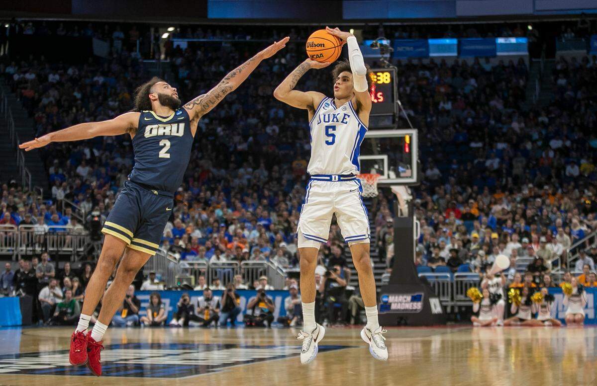 Duke’s Tyrese Proctor (5) launches a three point shot over Oral Roberts’ Kareem Thompson (2) in the second half during the first round of the NCAA Tournament on Thursday, March 16, 2023 at the Amway Center in Orlando, Fla.