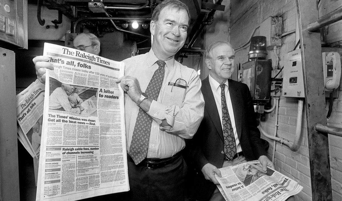 Publisher Frank Daniels Jr.and Raleigh Times Editor A.C. Snow look over the final edition of the Raleigh Times as it rolls off the presses on November 30, 1989 in Raleigh, N.C.