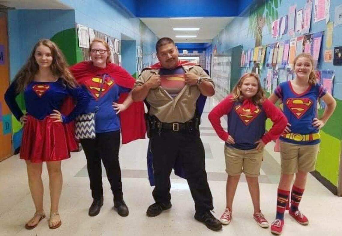 Officer Bud (center) worked as a school resource officer at East Montgomery Middle.