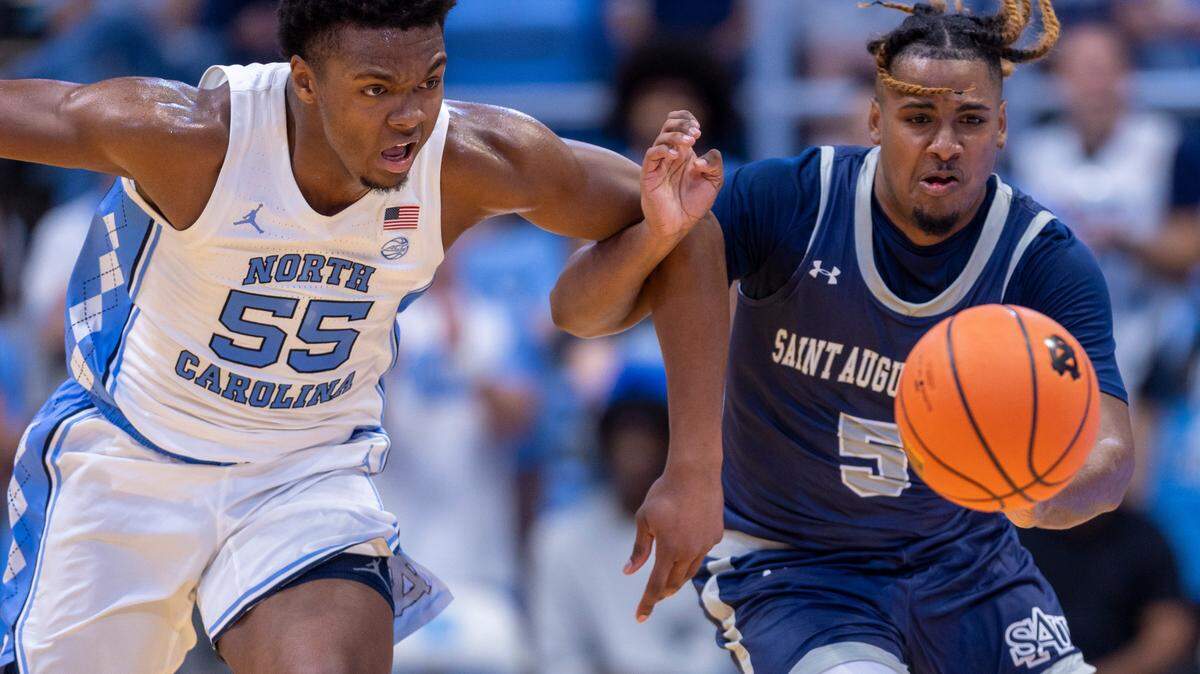North Carolina’s Harrison Ingram (55) goes after the ball with St. Augustine’s Kaleb Glasser (5) in the first half on Friday, October 27, 2023 at the Smith Center in Chapel Hill, N.C.