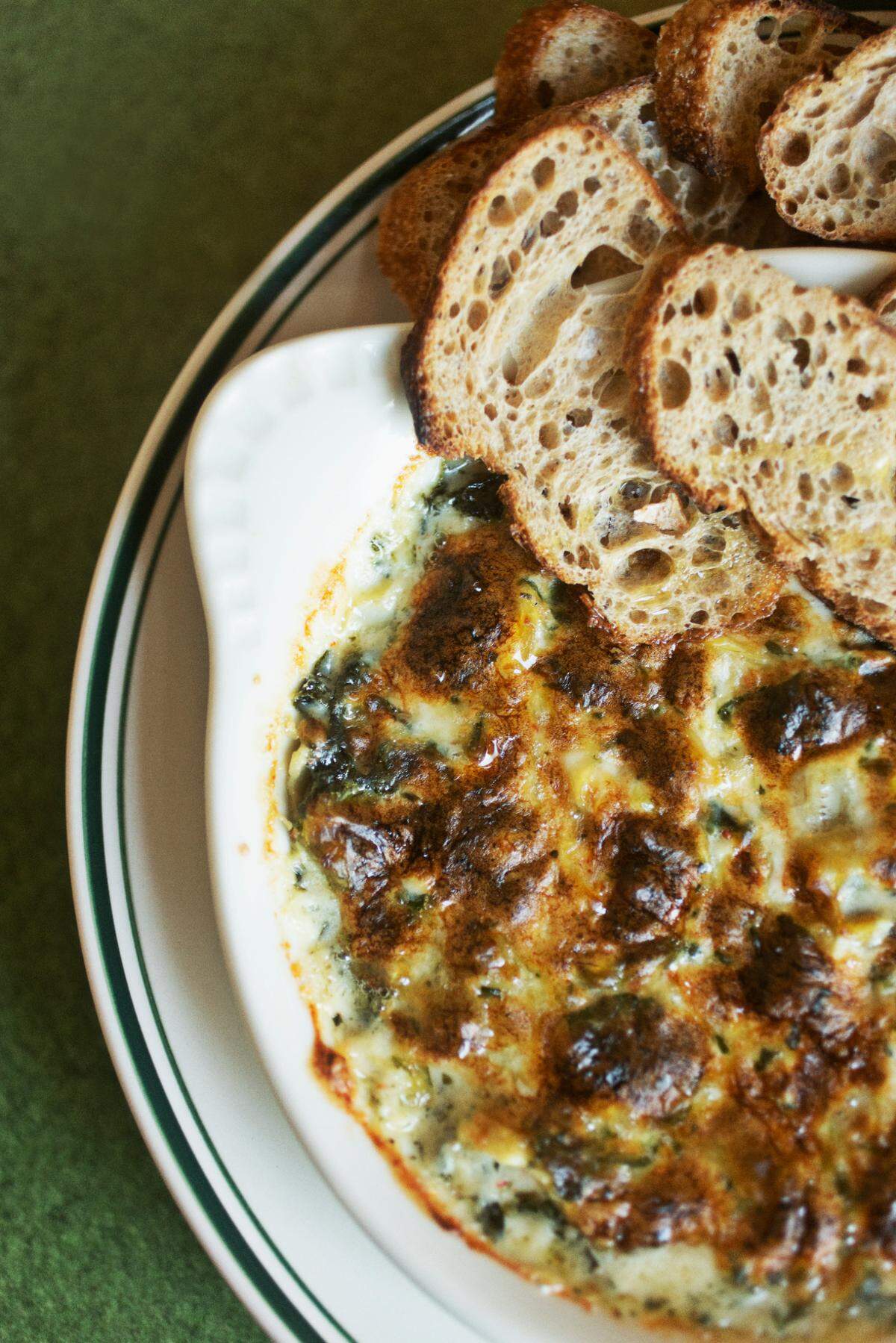 Spinach Artichoke Dip is served with Union Special Bread at Fine Folk restaurant in Raleigh on Wednesday afternoon, April 13, 2022.