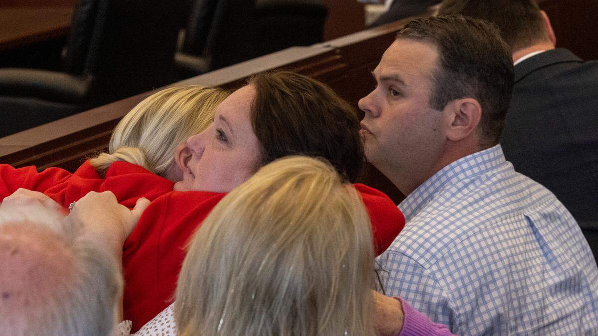 April and Trey Brooks, the parents of Hailey Brooks, the 11-year-old who was struck and killed during the Raleigh Christmas Parade, are comforted by friends and family during a bond hearing for Landon Glass, the driver who lost control of his truck. Glass faces a felony involuntary manslaughter charge.