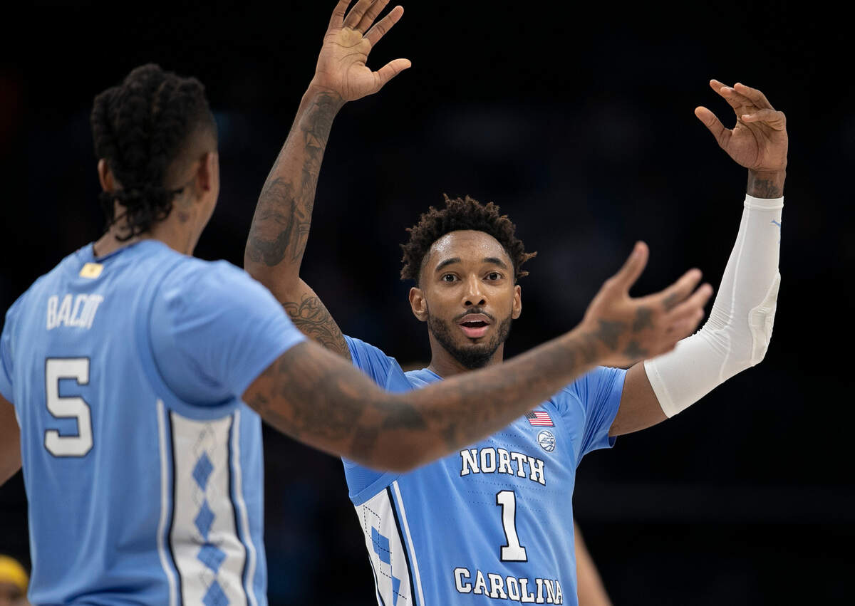 North Carolina’s Armando Bacot (5) and Leaky Black (1) celebrate their 80-76 victory over Michigan on Wednesday, December 21, 2022 at the Spectrum Center in Charlotte, N.C.