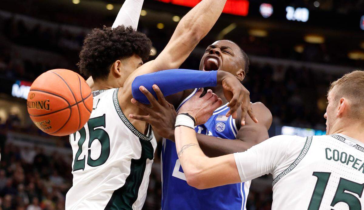 Duke’s Mark Mitchell (25) is fouled as he is defended by Michigan State’s Malik Hall (25) and Carson Cooper (15) during the second half of Duke’s 74-65 victory over Michigan State in the Champions Classic at the United Center in Chicago, IL, Tuesday, Nov. 14, 2023.
