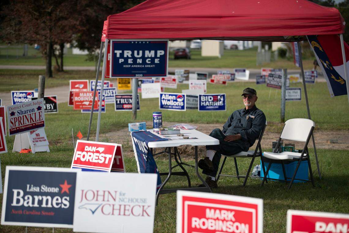 Volunteer Pete Eatmon mans the Nash County Republican Party tent outside the early voting site at the Mt. Pleasant Community Center near Bailey, N.C. on Thursday, October 22, 2020.