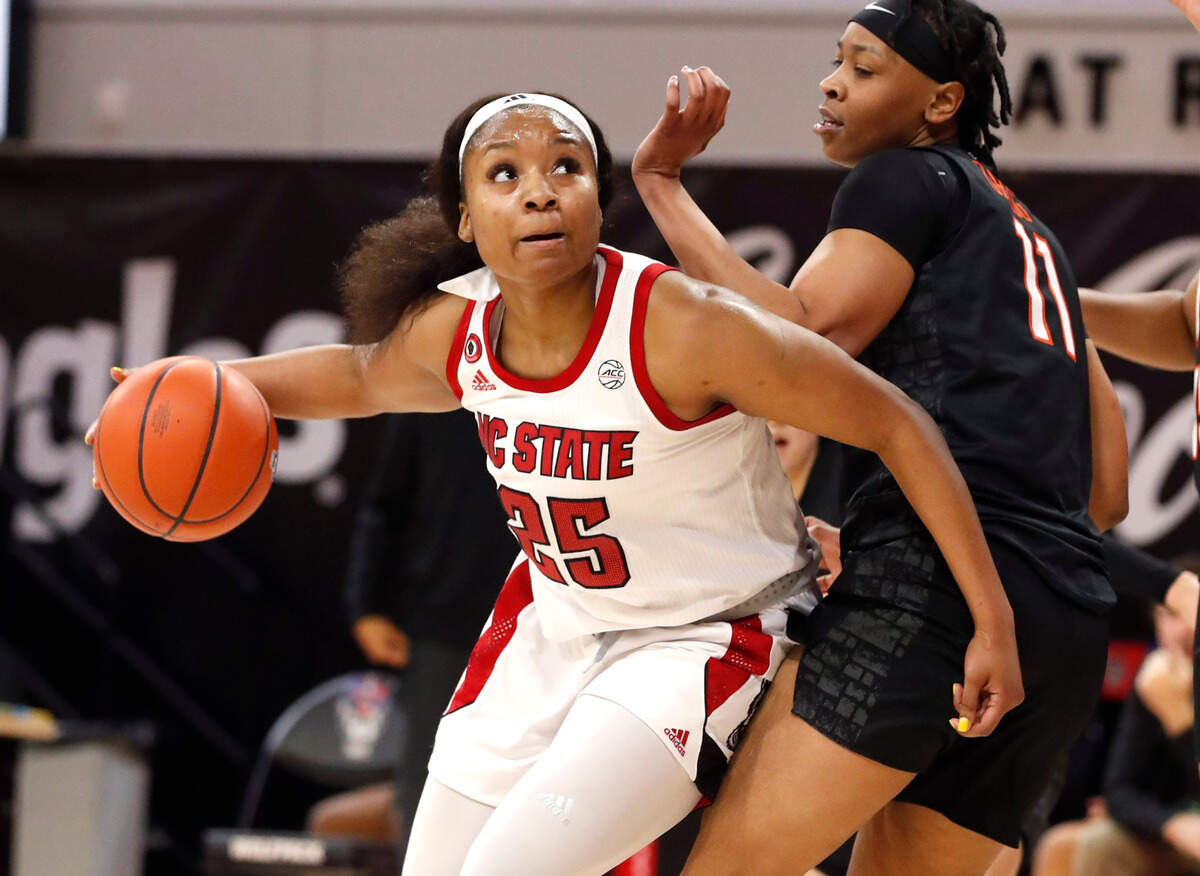 N.C. State’s Kayla Jones (25) drives around Virginia Tech’s D’asia Gregg (11) during the first half of N.C. State’s game against Virginia Tech at Reynolds Coliseum in Raleigh, N.C., Sunday, January 24, 2021.