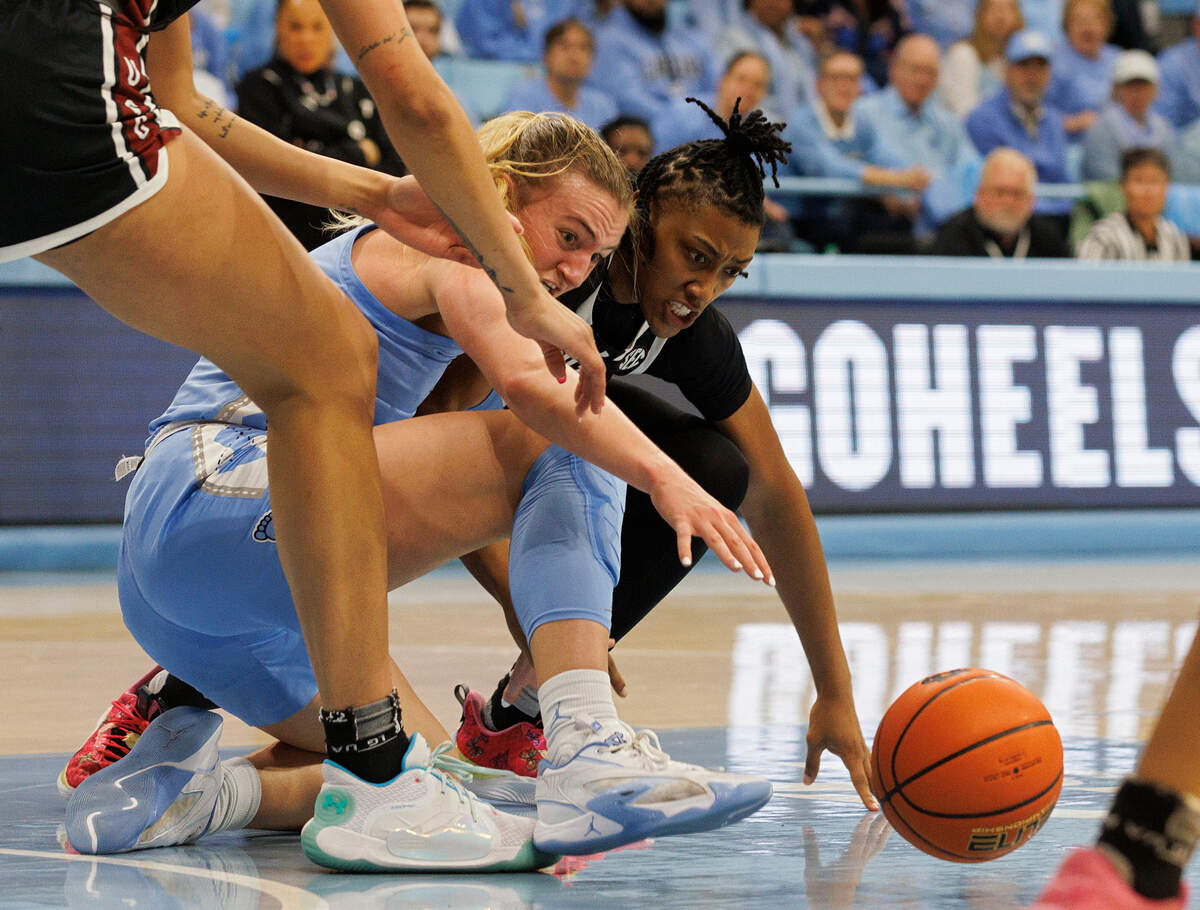 North Carolina’s Alyssa Ustby and South Carolina’s Ashlyn Watkins dive for a loose ball during the first half of the Tar Heels’ game on Thursday, Nov. 30, 2023, at Carmichael Arena in Chapel Hill, N.C.