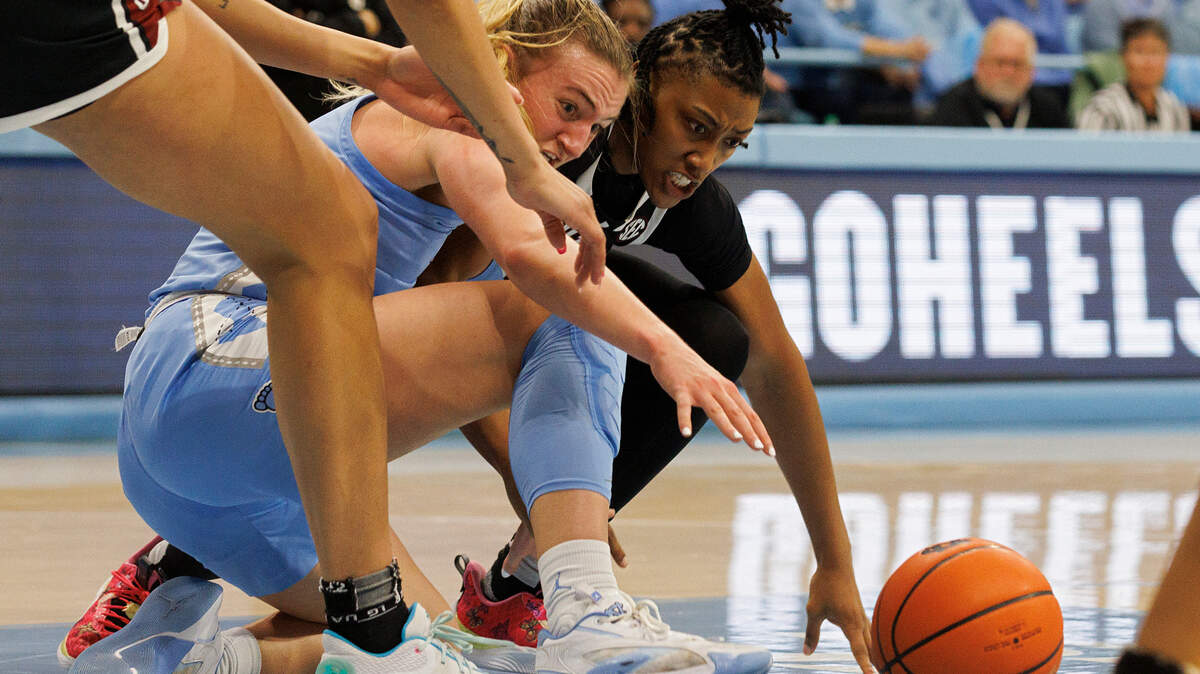 North Carolina’s Alyssa Ustby and South Carolina’s Ashlyn Watkins dive for a loose ball during the first half of the Tar Heels’ game on Thursday, Nov. 30, 2023, at Carmichael Arena in Chapel Hill, N.C.
