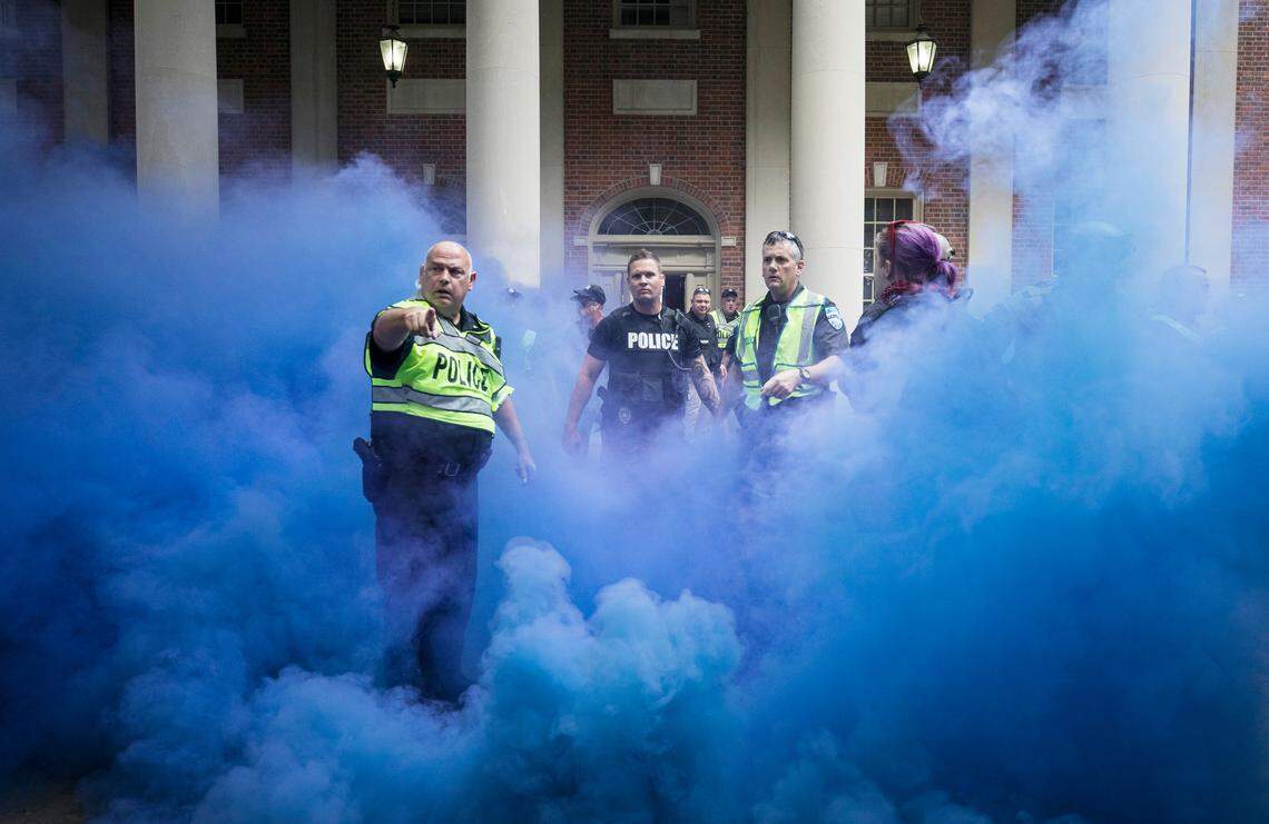 Police deployed smoke bombs into a crowd to disperse protesters after making arrests on the campus of the University of North Carolina in Chapel Hill, NC Saturday, Sept. 8, 2018. Supporters and opponents of the Silent Sam statue faced off again late Saturday afternoon on the UNC campus, yelling at each other at the base where the Confederate monument was toppled last month.