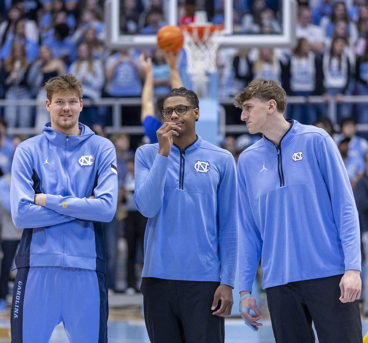 North Carolina center Henri Veesaar (13) stands with teammates James Brown (2) and Ivan Matlekovic (40) as they watch their teammates warm up for their game against Pitt. Veesaar is recovering from illness and an injury.