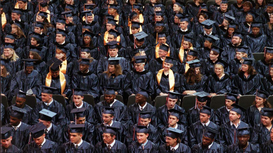 Students prepare to receive diplomas at a Wake Tech graduation.