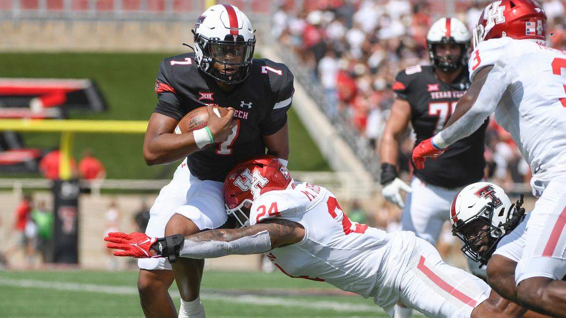 Texas Tech quarterback Donovan Smith (7) runs the ball while Houston linebacker Malik Robinson (24) defends during their game Saturday, Sept. 10, 2022, in Lubbock, Texas