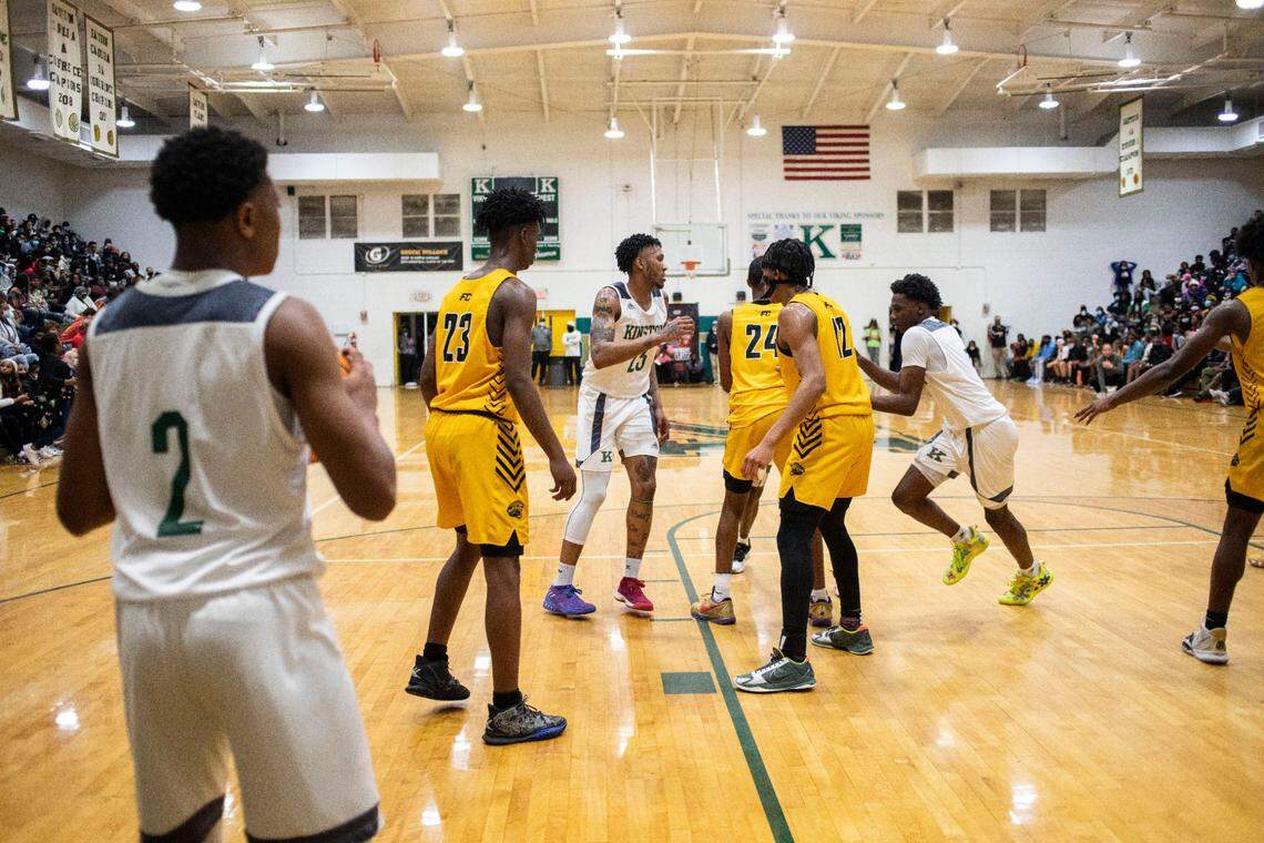 Kinston Vikings player Dontae Ellis, left, looks to his teammates Jeremy Dixon, middle, and Jaylen Cobb, right before throwing the ball in during their game against Farmville Central at the Brandon Ingram MLK Showcase in Kinston, N.C. on Saturday, Jan. 15, 2022.