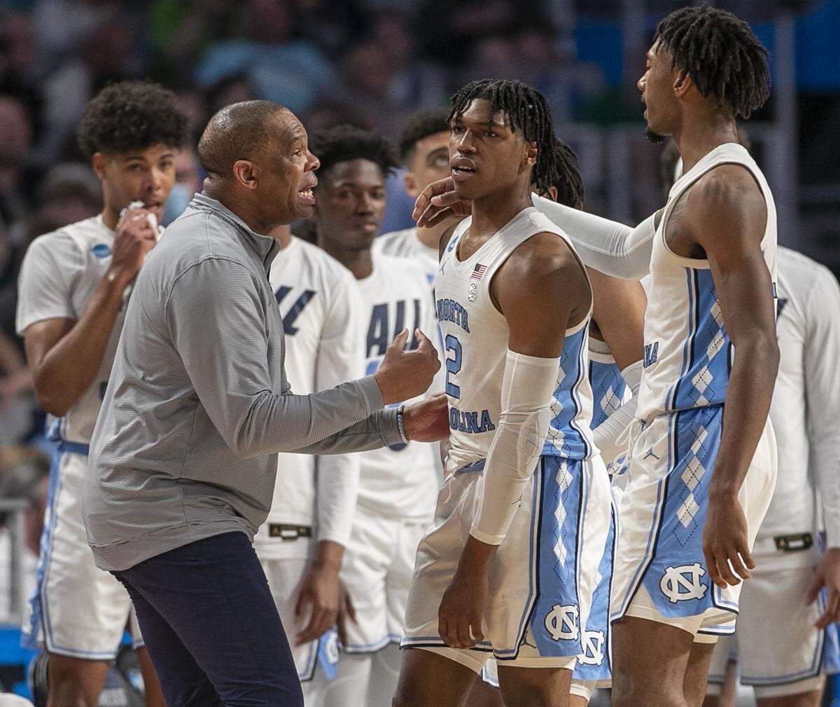 North Carolina coach Hubert Davis and Leaky Black (1) work to calm Caleb Love (2) after an altercation with Marquettes Darryl Morsell (32) during the first half on Thursday, March 17, 2022 during the NCAA Tournament at Dickies Arena in Ft. Worth, TX.