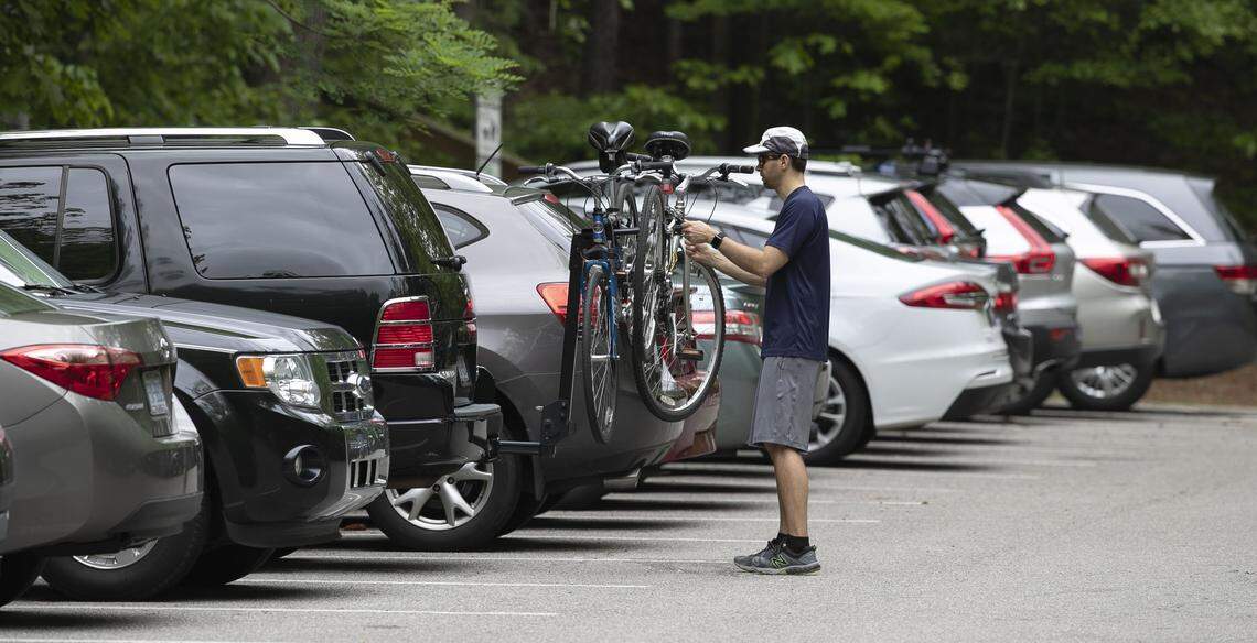 Kevin Rewkowski removes bikes from his car before hitting the popular Walnut Creek Greenway which connects to Lake Johnson Park on Sunday, April 26, 2020 in Raleigh, N.C.