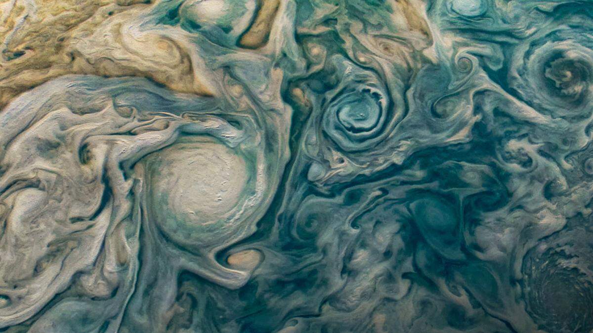 This photograph, as seen in the PBS series “NOVA: The Planets,” is a NASA satellite image showing Jupiter covered in storms. Thousands of kilometers across, these storms are larger than anything we see on Earth.