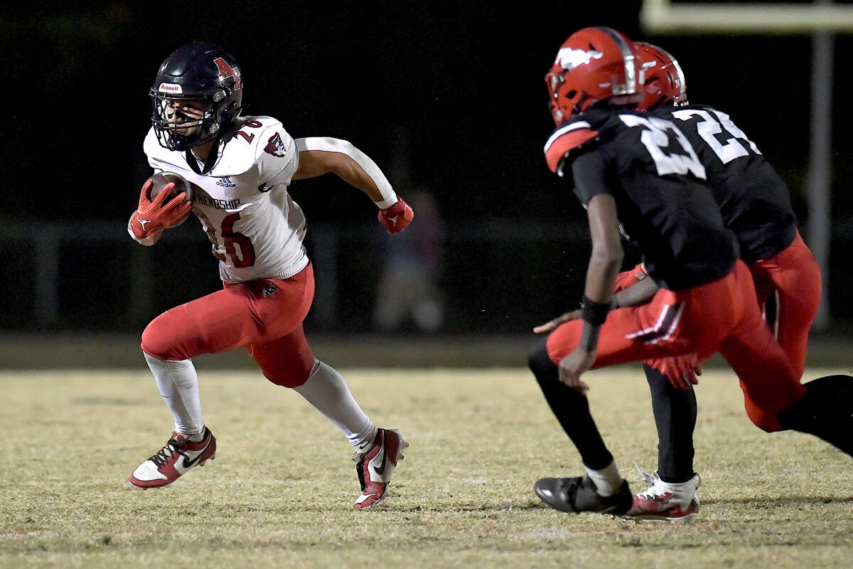Apex Friendship running back Jaden Avery (26) scrambles for yards against the Middle Creek defense during the first half. The Middle Creek Mustangs and the Apex Friendship Patriots met in a football game in Cary, N.C. on October 25, 2024.