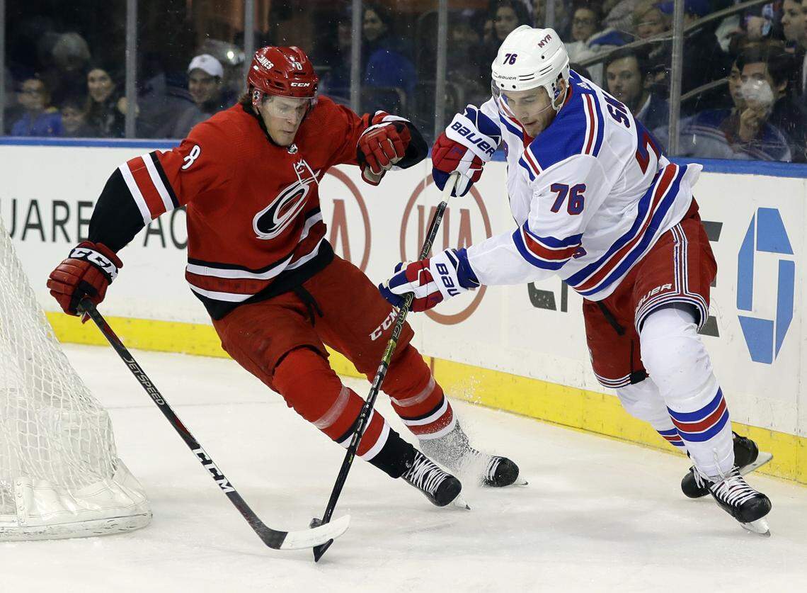 Carolina Hurricanes’ Saku Maenalanen (8) fights for control of the puck with New York Rangers’ Brady Skjei (76) during the first period of an NHL hockey game Friday, Feb. 8, 2019, in New York. (AP Photo/Frank Franklin II)