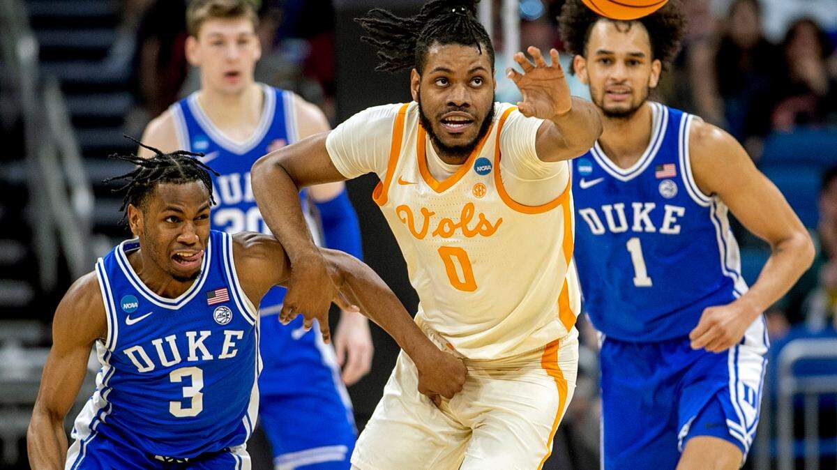 Duke’s Jeremy Roach (3) and Tennessee’s Jonas Aidoo (0) battle for a loose ball in the first half during the second round of the NCAA Tournament on Saturday, March 18, 2023 at the Amway Center in Orlando, Fla.