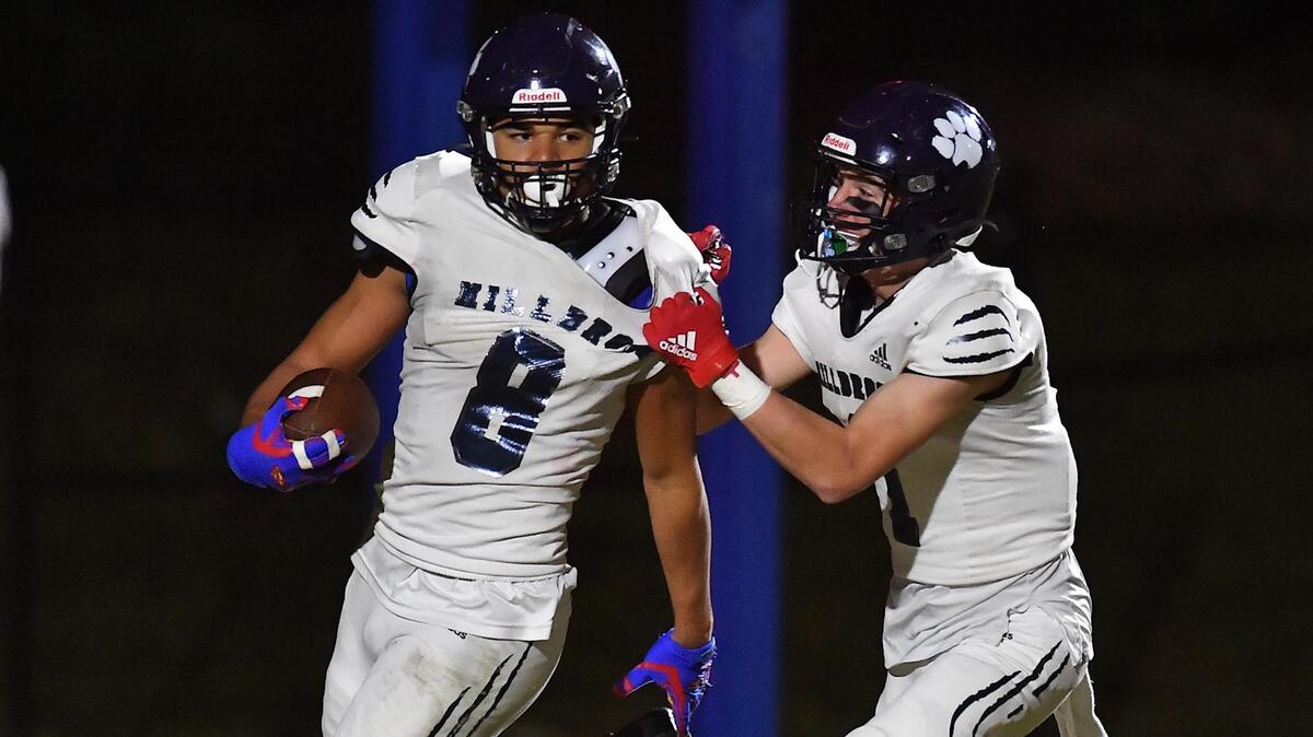 Milbrook’s Ty Broughton (1) celebrates with David Santiago (8) after his touchdown during the second half. The Wake Forest Cougars and the Millbrook Wildcats met in a football game in Wake Forest, N.C. on October 28, 2022.