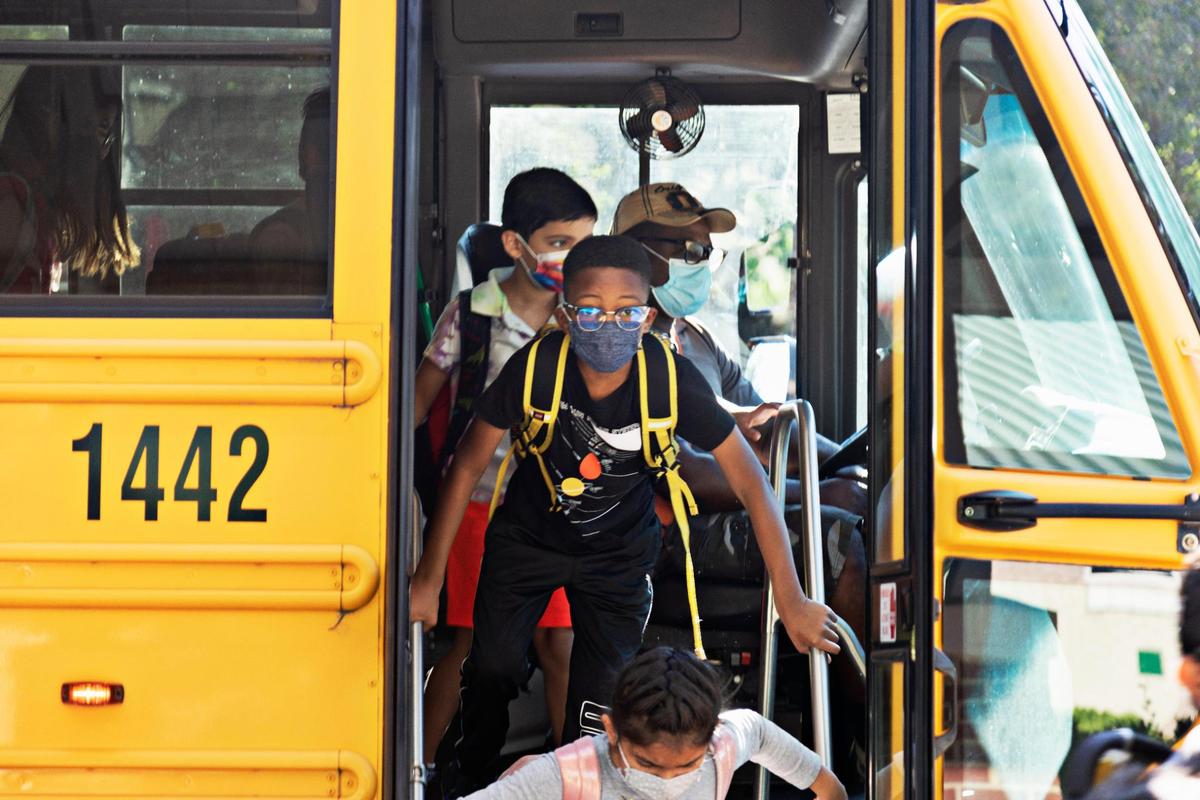 Students exit the bus to enter Carpenter Elementary School in Cary on Thursday morning, Aug. 19, 2021. North Carolina students will start their third school year dealing with the coronavirus pandemic just as the highly contagious delta variant is rapidly spreading across the state.