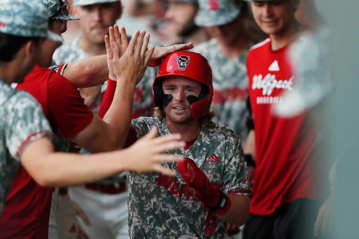 NC State’s Matt Heavner (6) celebrates with his teammates after scoring a run during Game 3 of the Super NCAA Regional against Georgia at Foley Field on Monday, June 10, 2024 in Athens, Ga. NC State won 8-5.