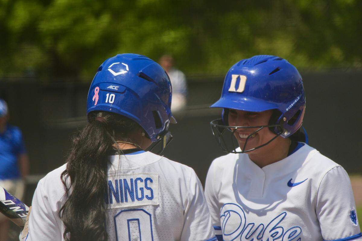 Duke outfielder D’Auna Jennings (10) and infielder Ana Gold (4) talk between innings during the Blue Devils’ 6-5 loss to Notre Dame on Saturday, April 19, 2025, at Duke Softball Stadium in Durham, N.C.