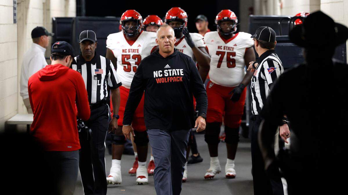 N.C. State head coach Dave Doeren leads his team out to the field before the Wolfpack’s game against Virginia at Scott Stadium in Charlottesville, Va., Friday, Sept. 22, 2023.