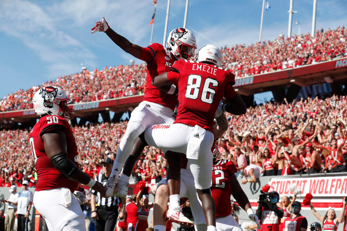 N.C. State’s Porter Rooks (4) celebrates with Emeka Emezie (86) after Emezie scored on nine-yard touchdown reception during the first half of N.C. State’s game against Clemson at Carter-Finley Stadium in Raleigh, N.C., Saturday, Sept. 25, 2021.
