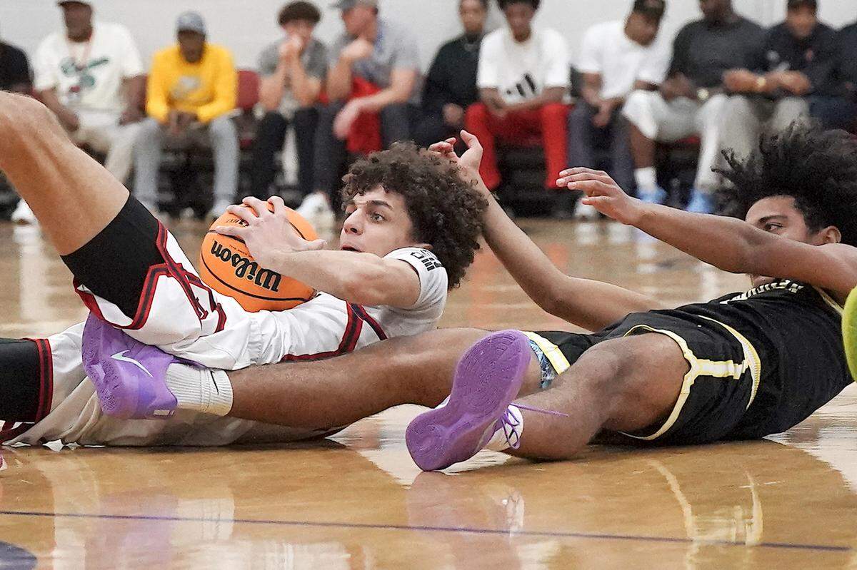 Davidson Day's Cody Peck (10) protects the loose ball away  from Southeastern Prep's Beckham Black (0) during the first half. The Davidson Day Patriots and the Southeastern Prep Academy National Falcons met in the John Wall Holiday Tournament in Raleigh, N.C. on December 27, 2025.