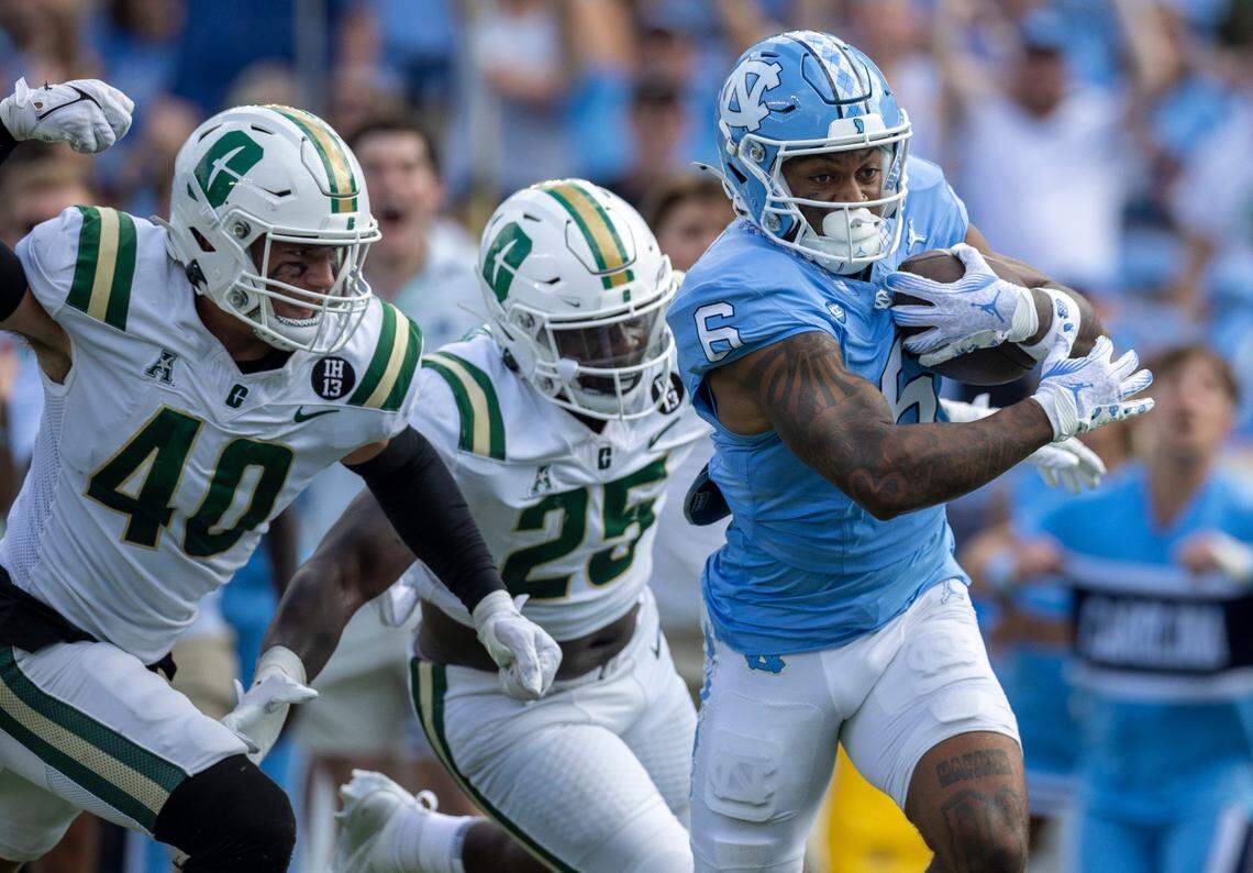 North Carolina wide receiver Nate McCollum (6) scores on a 37-yard carry ahead of Charlotte linebacker Reid Williford (4) to give the Tar Heels a 14-3 lead over Charlotte in the first quarter on Saturday, September 7, 2024 at Kenan Stadium in Chapel Hill, N.C.