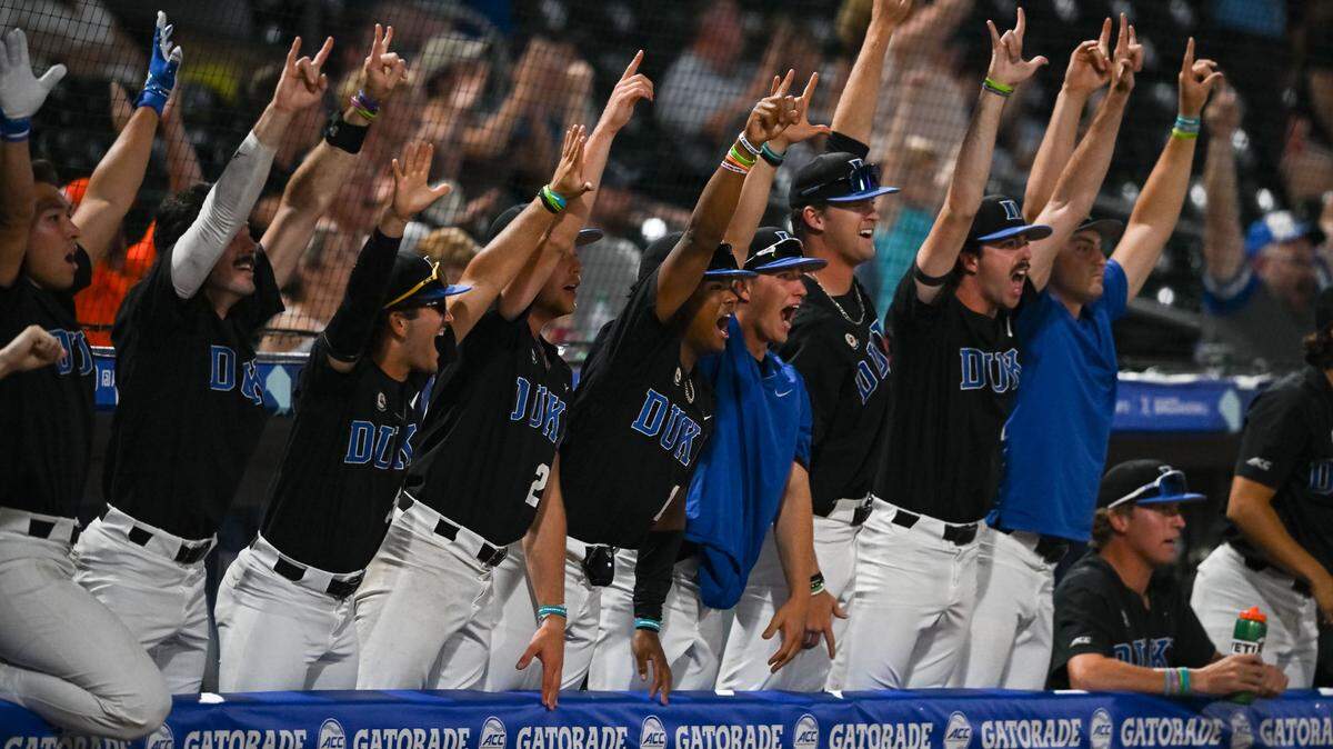 Duke’s players and coaches in the dugout celebrate during a rally that lifted the Blue Devils to a win in the ACC tournament semifinals at Truist Field earlier this season.