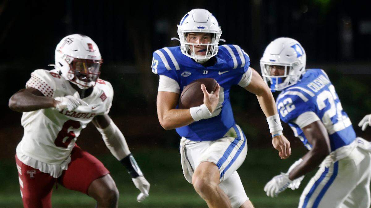 Duke quarterback Riley Leonard (13) runs the ball past Temple linebacker Jordan Magee (6) during the second half of the Blue Devilsí season opener at Wallace Wade Stadium on Friday, Sept. 2, 2022, in Durham, N.C.