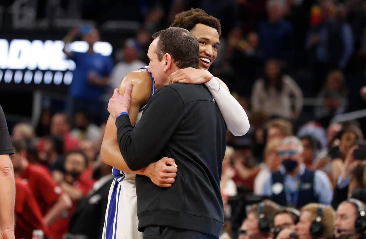 Duke head coach Mike Krzyzewski hugs Wendell Moore Jr. as time runs out in the game during Duke’s 78-69 victory over Arkansas in the NCAA Tournament West Regional finals at the Chase Center in San Francisco, Calif., Saturday, March 26, 2022.