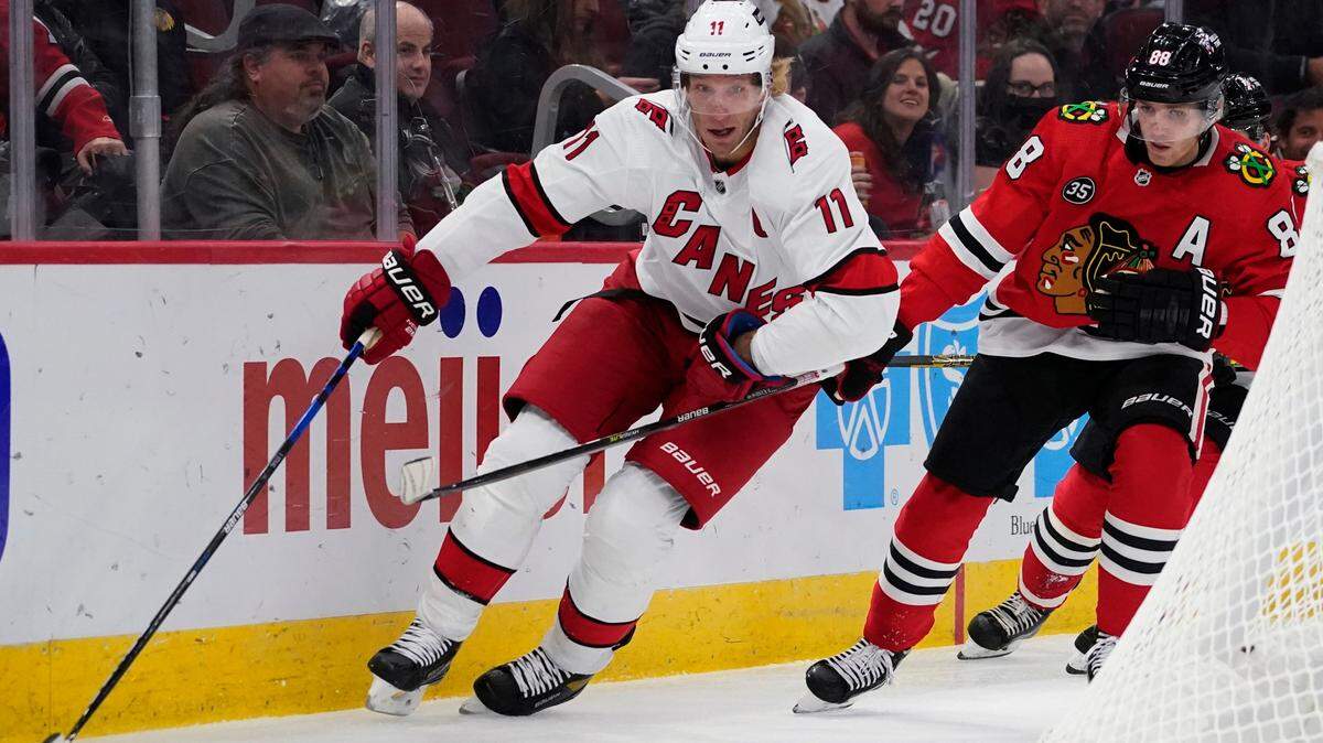 Carolina Hurricanes center Jordan Staal, left, chases the puck past Chicago Blackhawks right wing Patrick Kane during the first period of an NHL hockey game in Chicago, Wednesday, Nov. 3, 2021. (AP Photo/Nam Y. Huh)