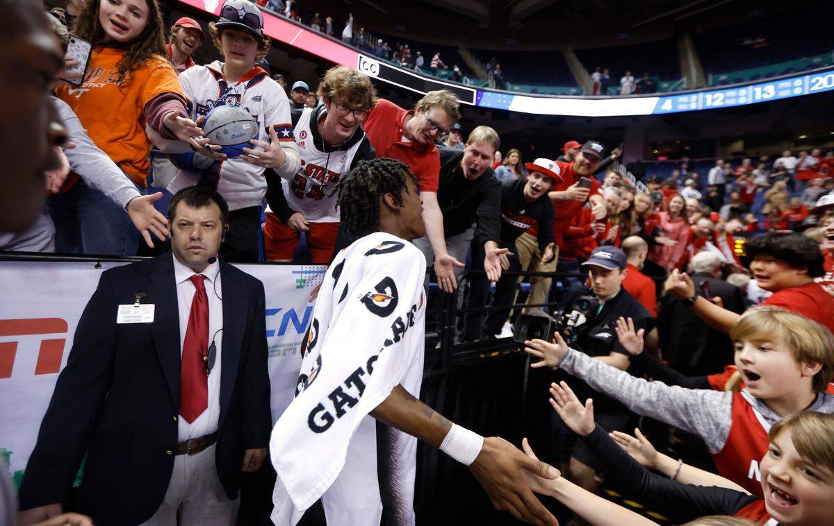 Fans greet N.C. State’s Terquavion Smith (0) as he walks off the court after the Wolfpack’s 97-77 victory over Virginia Tech in the second round of the ACC Men’s Basketball Tournament in Greensboro, N.C., Wednesday, March 8, 2023.